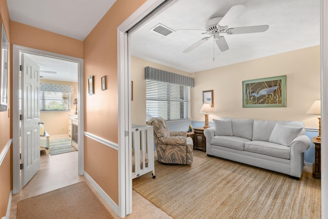 living room featuring ceiling fan and light tile patterned floors