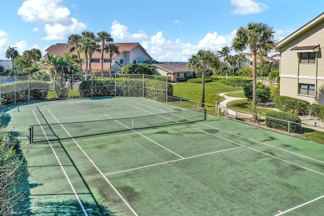 view of sport court with a yard