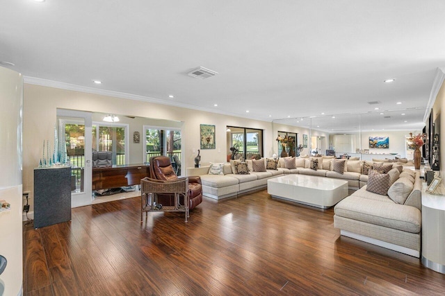 living room with crown molding and dark wood-type flooring