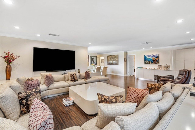 living room with crown molding and hardwood / wood-style floors