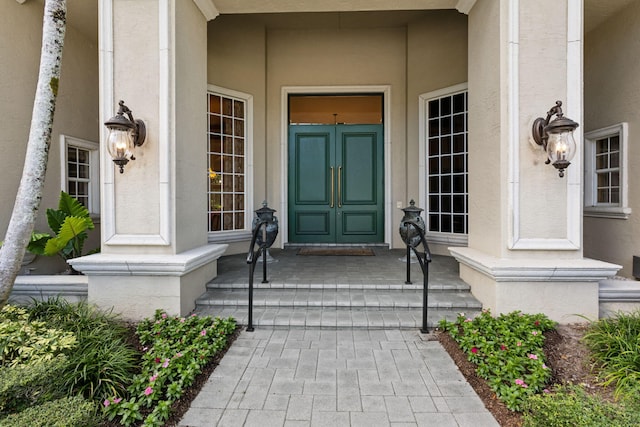 view of exterior entry with covered porch