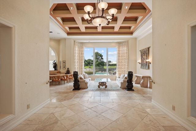 interior space with beam ceiling, an inviting chandelier, coffered ceiling, and ornamental molding