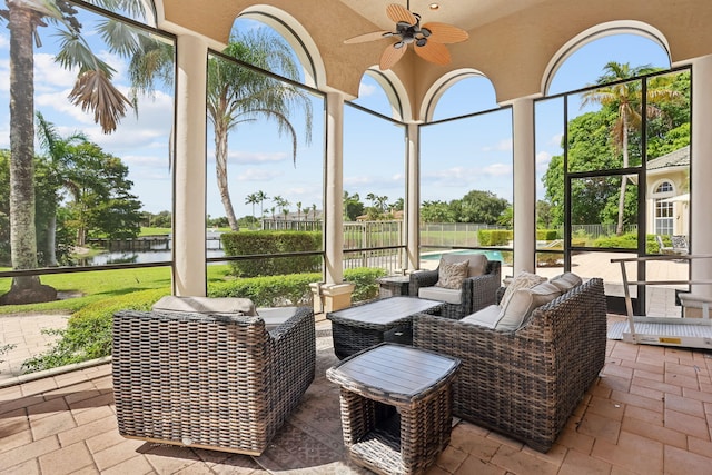 view of patio with ceiling fan and a water view