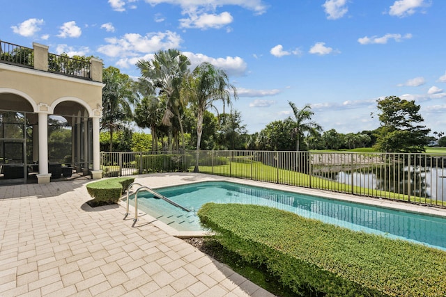 view of pool featuring a water view and a patio