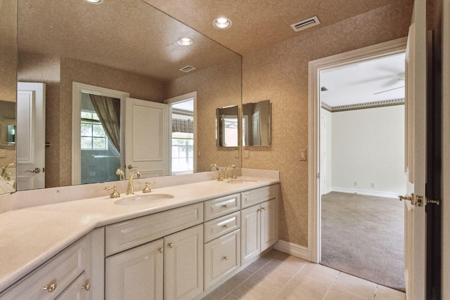 bathroom featuring a textured ceiling, vanity, and tile patterned floors