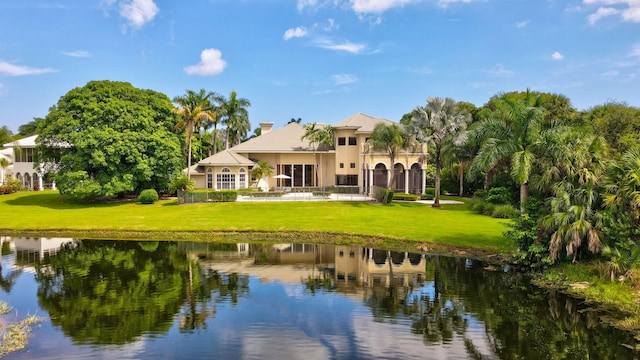 rear view of property featuring a water view