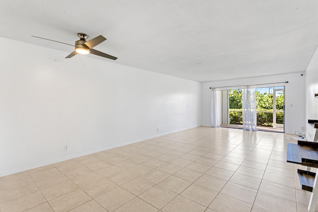 tiled spare room with ceiling fan