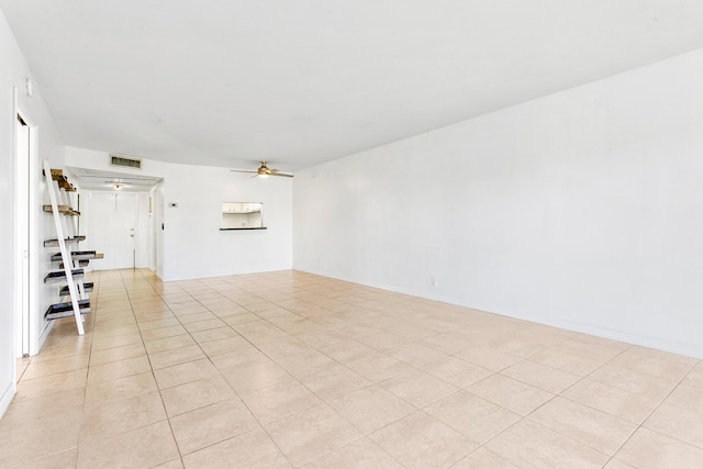 unfurnished room with ceiling fan and light tile patterned flooring