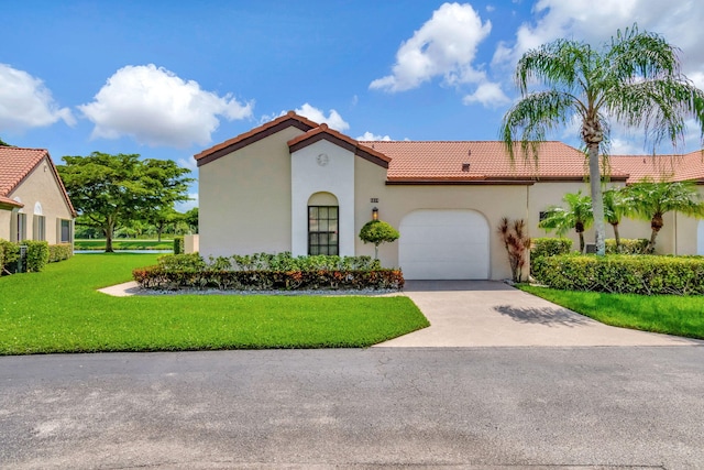 mediterranean / spanish-style house with a front yard and a garage