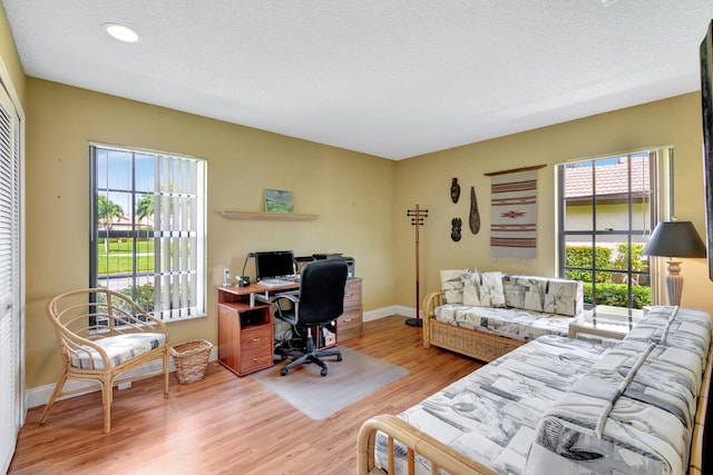 office area featuring a textured ceiling, hardwood / wood-style floors, and a wealth of natural light