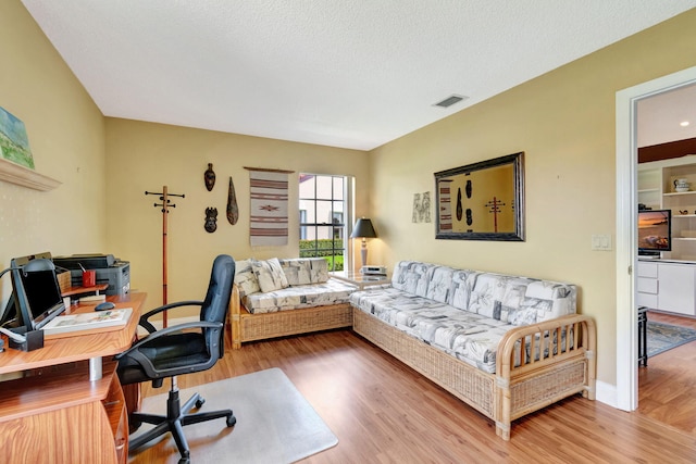 office space with a textured ceiling and hardwood / wood-style floors