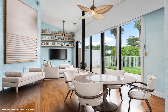 sunroom featuring vaulted ceiling and ceiling fan