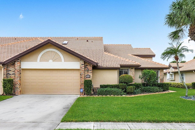 view of front facade with a garage and a front lawn