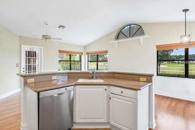kitchen with sink, vaulted ceiling, light hardwood / wood-style floors, white cabinets, and stainless steel dishwasher