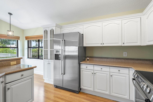 kitchen with white cabinets and appliances with stainless steel finishes
