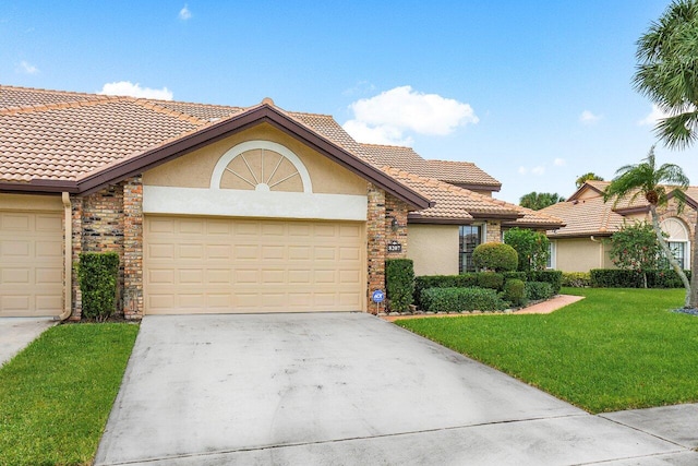 view of front of house featuring a front yard and a garage