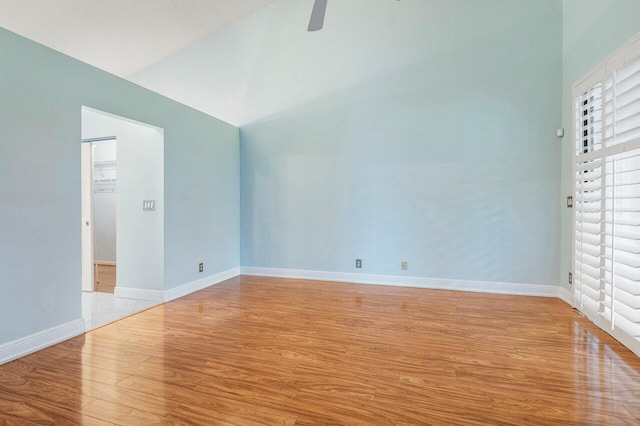 interior space with light hardwood / wood-style floors, ceiling fan, a textured ceiling, lofted ceiling, and a closet