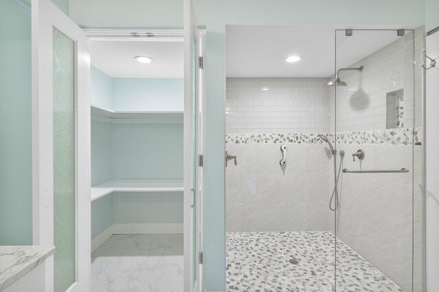bathroom with tiled shower