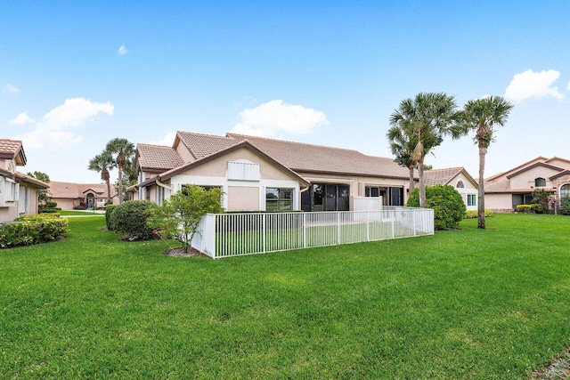 rear view of property with a lawn