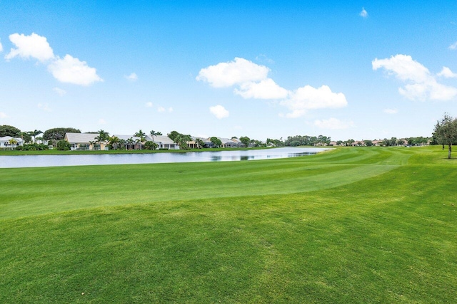 surrounding community featuring a lawn and a water view