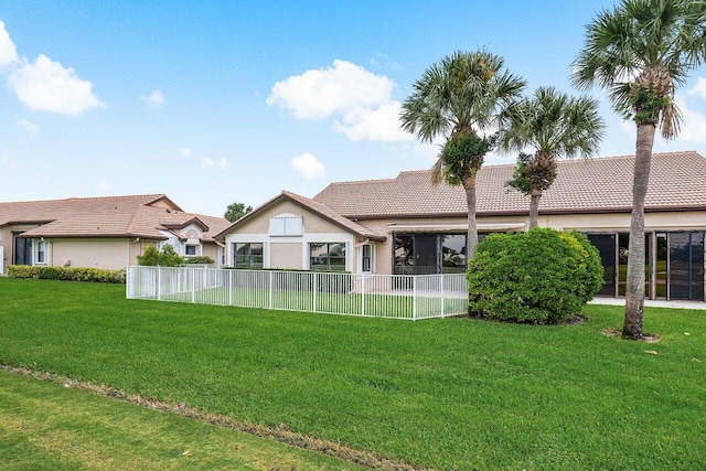 rear view of property with a lawn