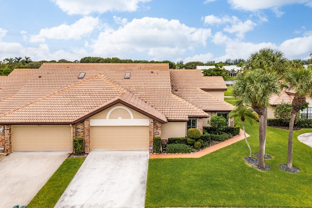 mediterranean / spanish house featuring a front lawn and a garage