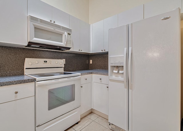 kitchen featuring white cabinets, light tile patterned floors, white appliances, and tasteful backsplash