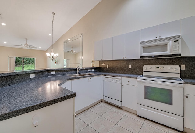 kitchen with white cabinetry, ceiling fan with notable chandelier, white appliances, pendant lighting, and lofted ceiling