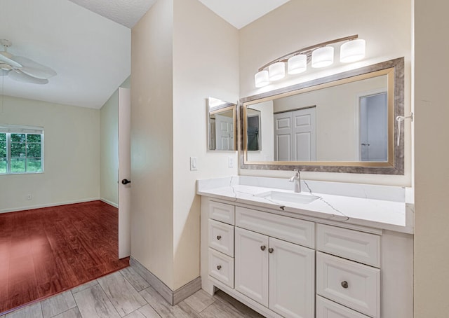 bathroom featuring wood-type flooring, vanity, and a textured ceiling