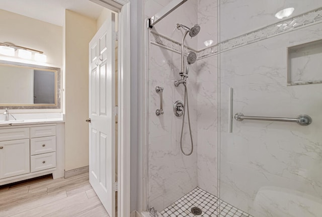 bathroom featuring vanity and tiled shower