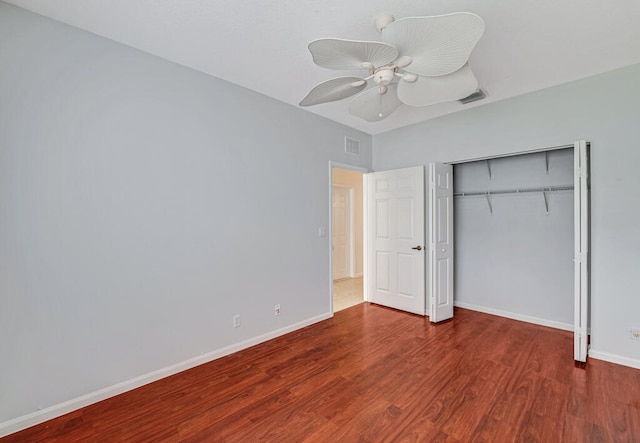 unfurnished bedroom featuring hardwood / wood-style floors, ceiling fan, and a closet