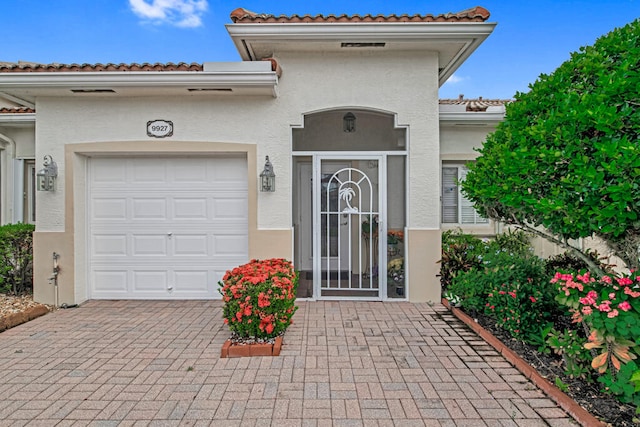 view of exterior entry with a garage