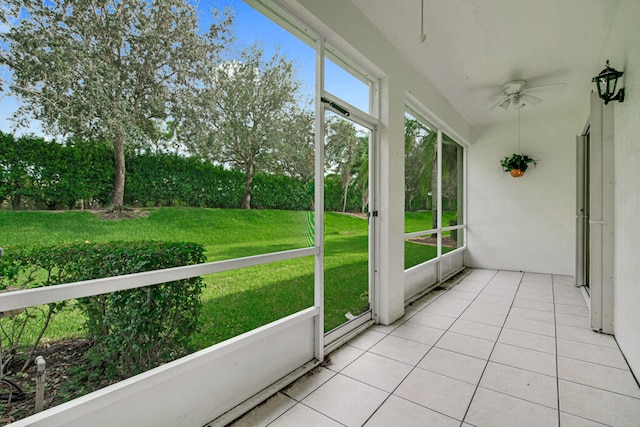 unfurnished sunroom with ceiling fan