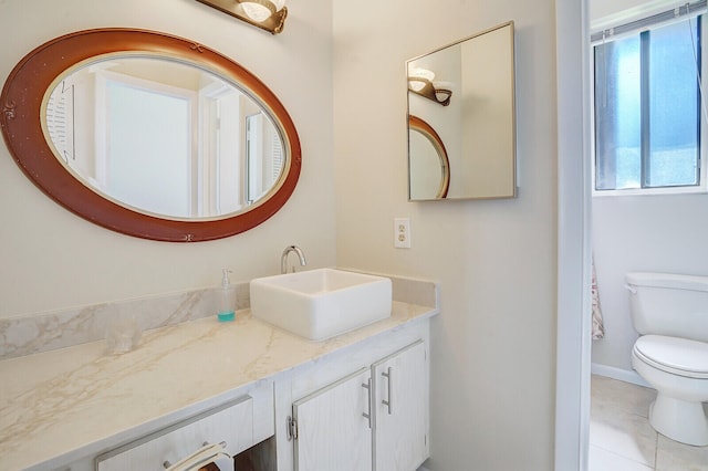 bathroom with tile patterned floors, vanity, and toilet