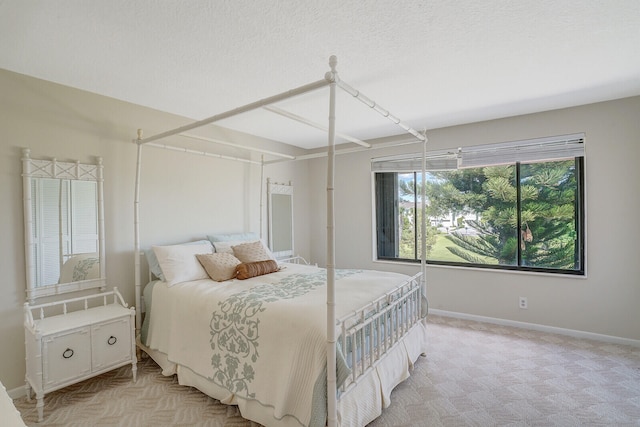 bedroom with light carpet and a textured ceiling