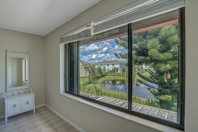 interior space with access to outside and a water view