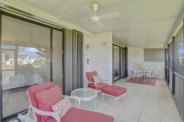 sunroom with wood ceiling and ceiling fan