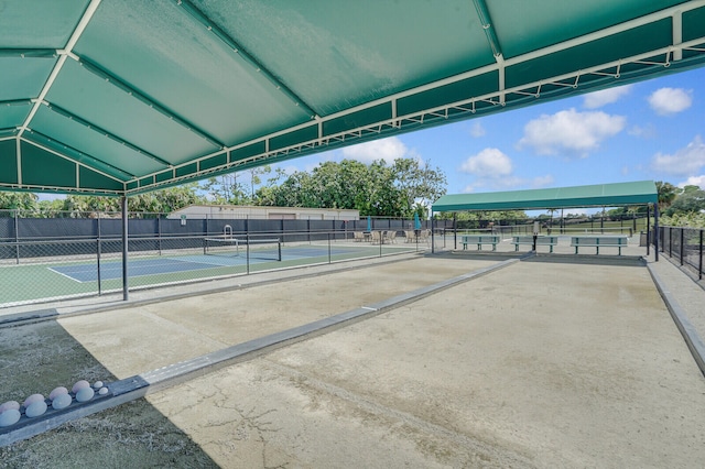 view of home's community with tennis court