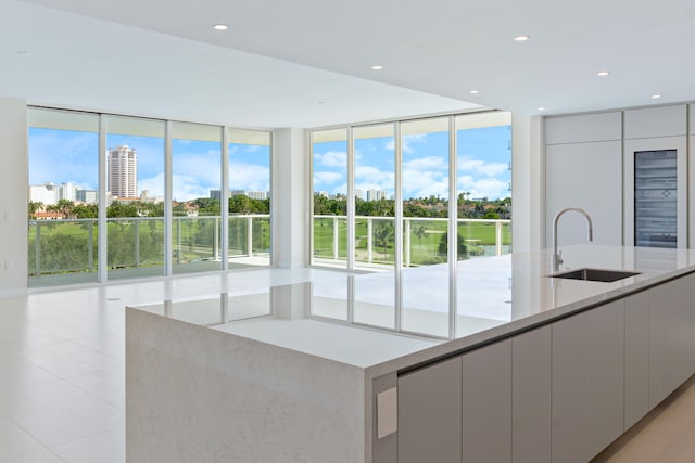 kitchen with a large island, a healthy amount of sunlight, and sink