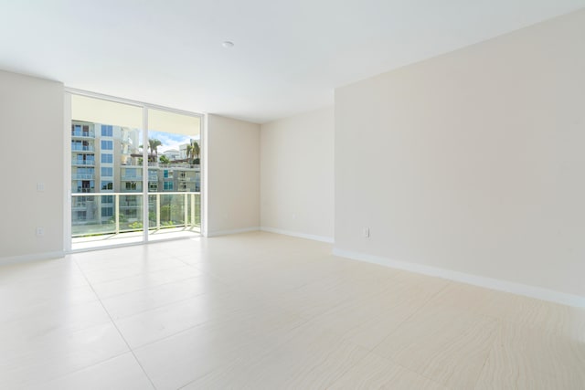 unfurnished room featuring expansive windows, light tile patterned floors, and a healthy amount of sunlight