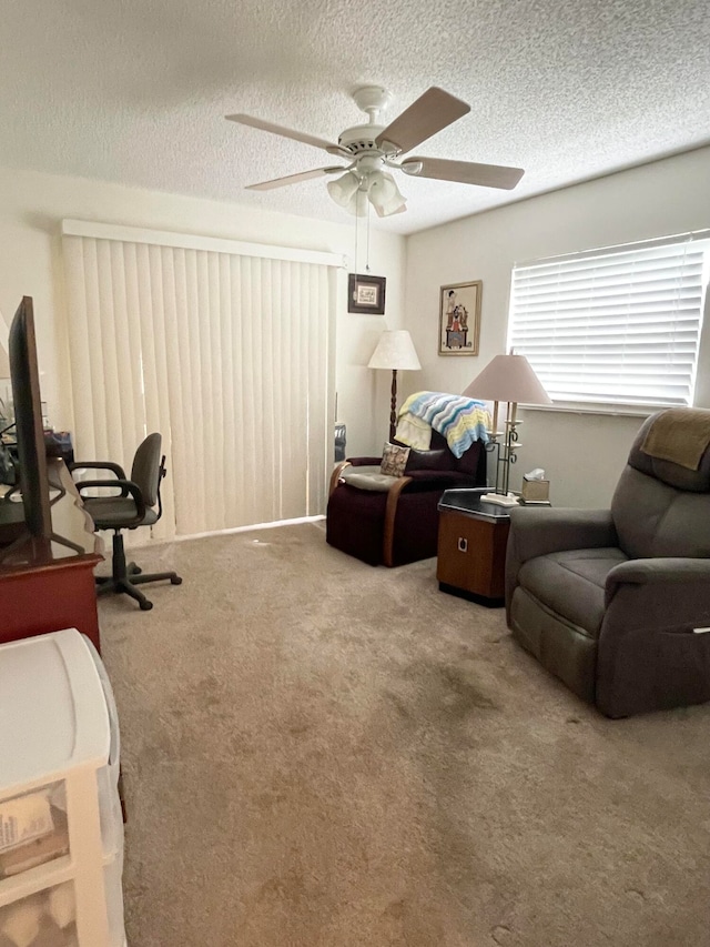 office area with ceiling fan, a textured ceiling, and carpet flooring