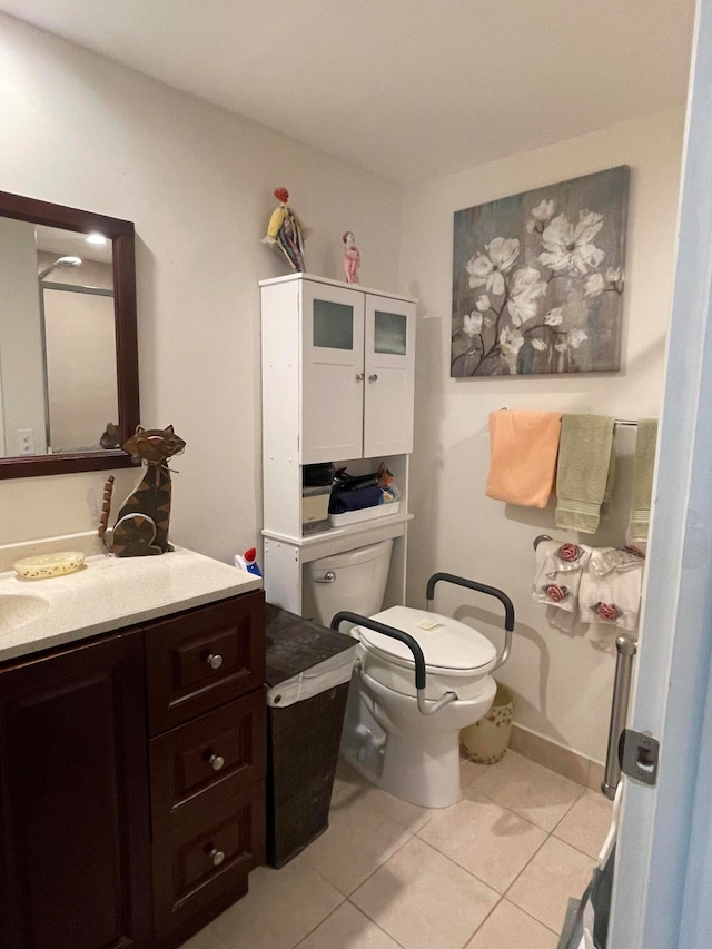 bathroom with vanity, toilet, and tile patterned floors