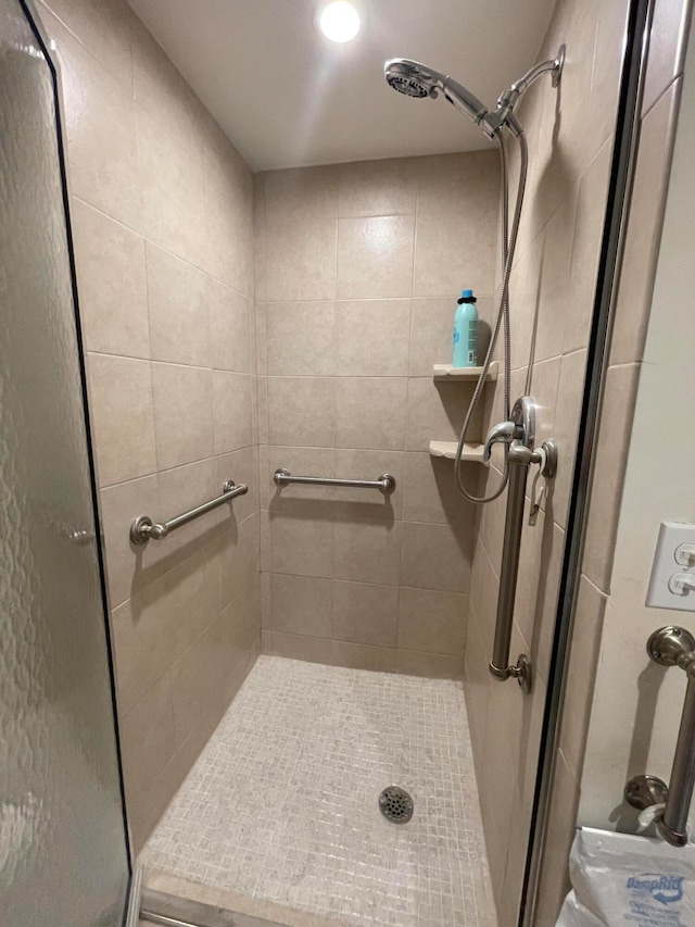 bathroom with a shower with shower door