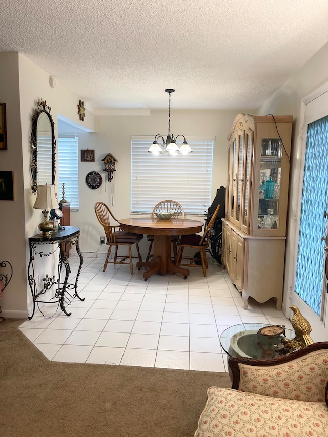 dining room with light tile patterned flooring, a chandelier, and a textured ceiling