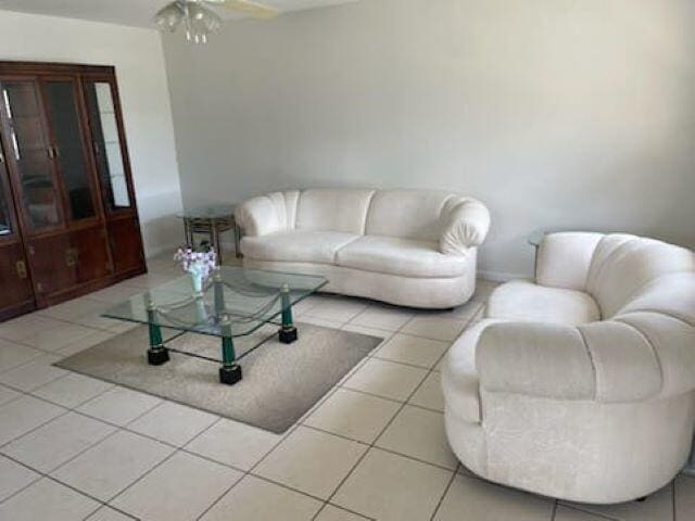 tiled living room with ceiling fan