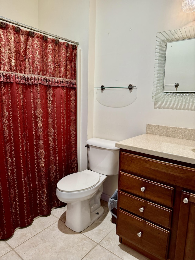 bathroom with tile patterned flooring, a shower with curtain, vanity, and toilet