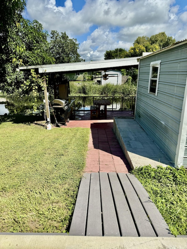 view of yard with a water view and a patio area