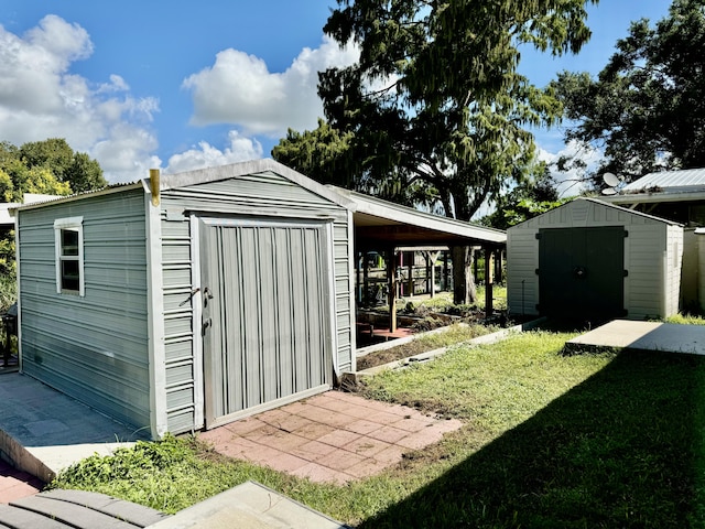 view of outbuilding with a carport and a yard