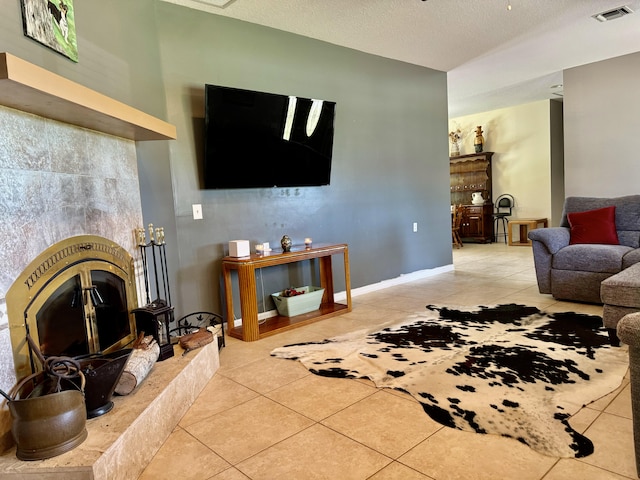 living room featuring a textured ceiling and light tile patterned floors