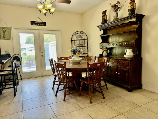 tiled dining room with ceiling fan and french doors